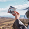 Insta360 Pocket Printer — Hand holding printed instant photos