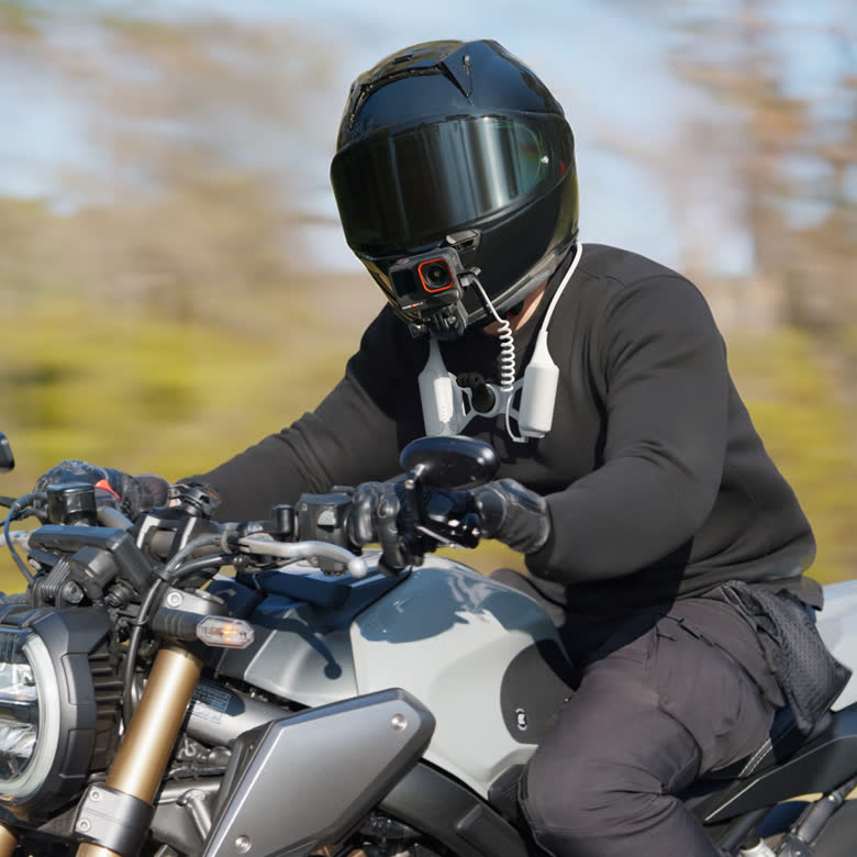Insta360 FOMO Power Neck Mount — Motorcyclist using it with helmet chin mount
