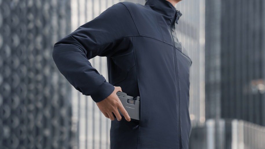 Antigravity A1 Charging Hub — Compact hub slipped into jacket pocket